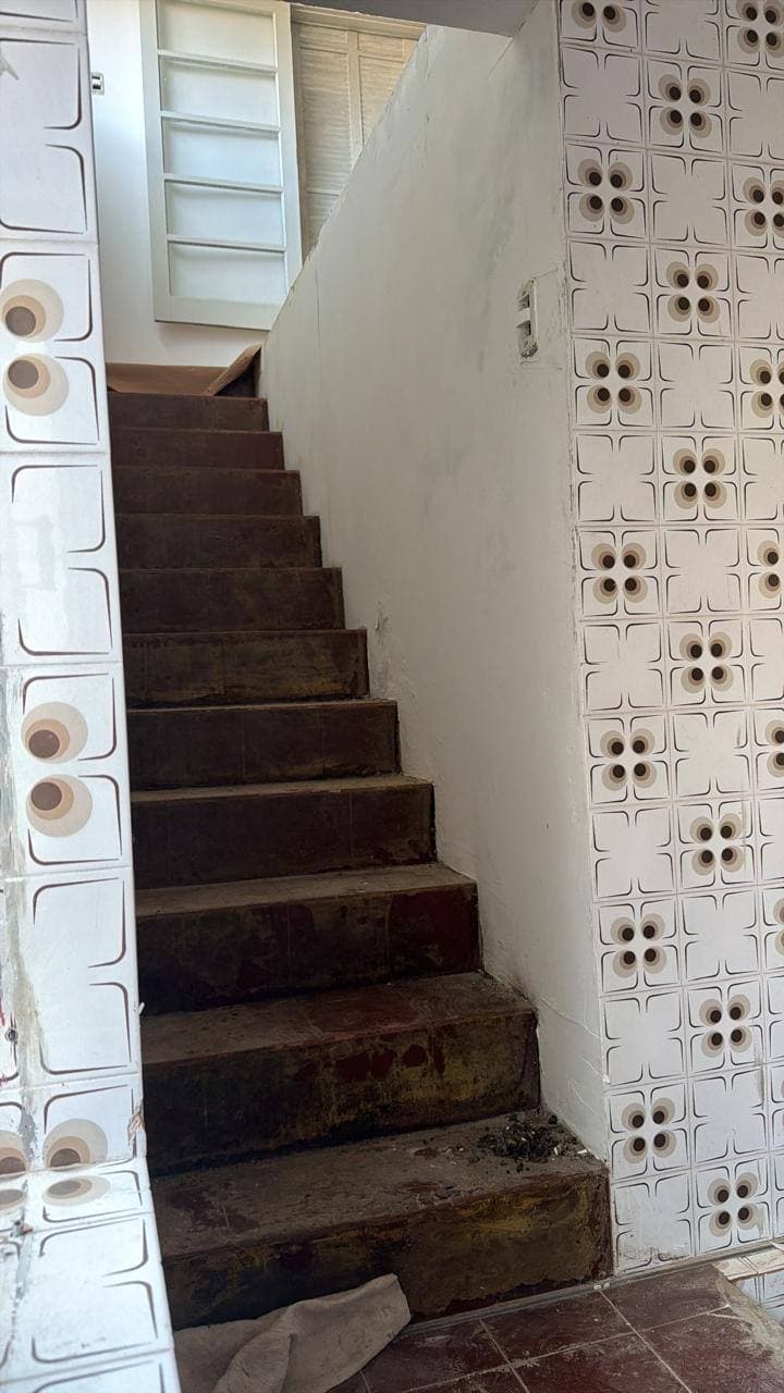 Escada antiga, com revestimento danificado, antes da reforma